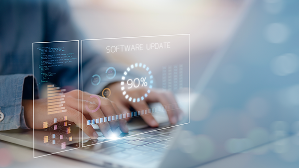 Person typing on laptop with 90% software update progress bar displayed.