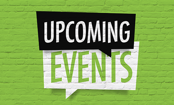 Upcoming events sign on green brick wall background for event announcements and promotions.